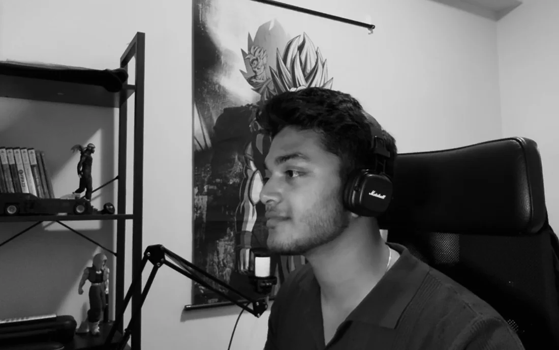 Zubin at his desk with headphones on, working with a pen tablet