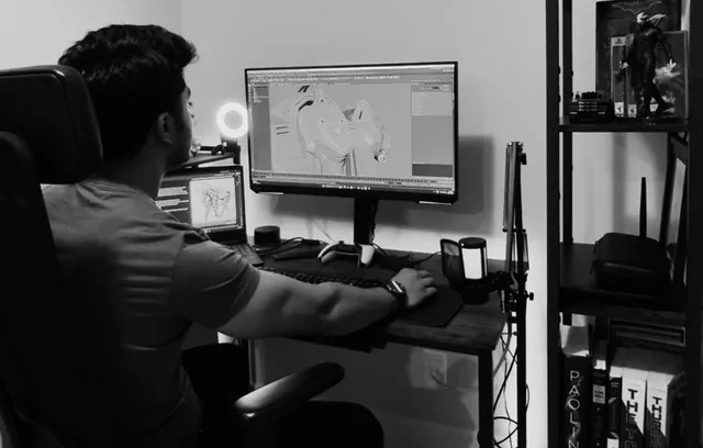 Zubin at his desk modelling a mech in Maya